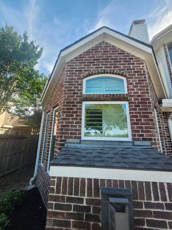 Custom arched window on brick home